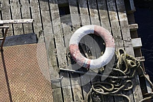 Water safety buoy red white ring aerial view from above on wooden raft