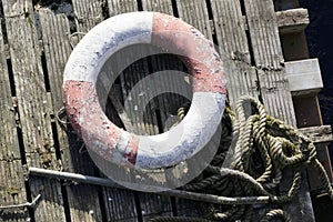 Water safety buoy red white ring aerial view from above on wooden raft