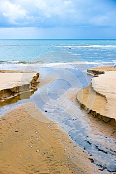 Water and sand on the shoreline in Follonica, Italy