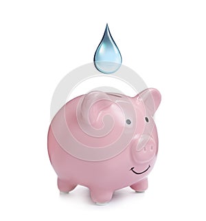 Water scarcity concept. Piggy bank and drop on white background