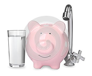 Water scarcity concept. Piggy bank, tap and glass of drink on white background