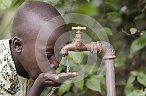 Water scarsity in the world symbol. African boy begging for water. In places like sub-Saharan Africa, time lost to gather water