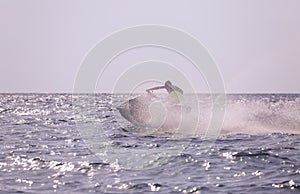 The water scooter turns around leaving a cloud of spray behind it