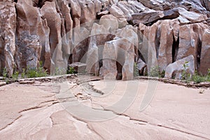 Water-Sculpted Rocks and Sand in Desert Canyon photo
