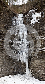 Water seeping out of a rock wall forms natural icicles along the gorge trail at Buttermilk Falls State Park, Ithaca, New York, US