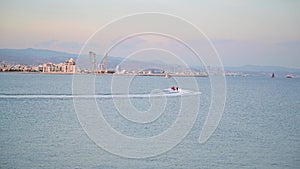 Water skiing on the sea behind a motorboat at sea bay