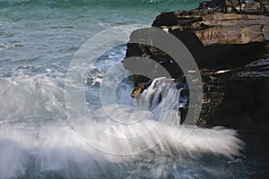 The water slides between the rocks with small waterfalls photo