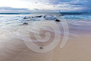 Water in slow motion on a sandy beach