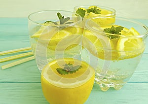 Water soda lemon tube citrus detox refreshment , liquid homemade health mint summer on a blue wooden background