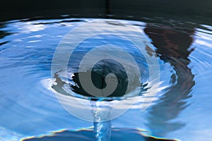 Water spiralling down a drain