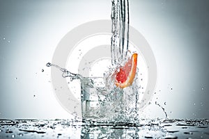 Water splash in glass of gray color