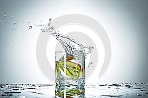 Water splash in glass of gray color