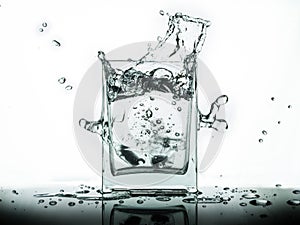 Water splash in glass isolated on white background..