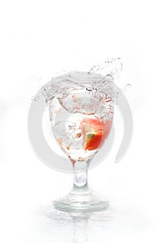 Water splash on the glass with tomato photo