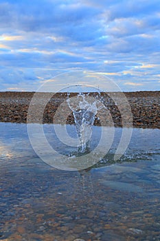 Water splash on the pebble beach