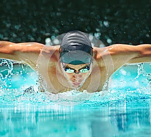Water splash, sport and training with man in swimming pool for competition, workout and energy. Strong, fitness and