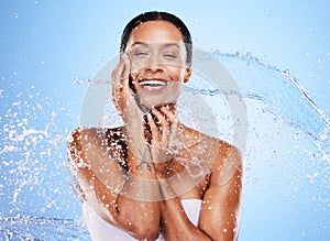 Water splash, woman and skincare for beauty, moisturizer or hydration by blue background wall. Black woman, skin model