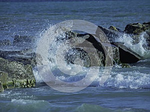 Water Splashes Against The Rocks