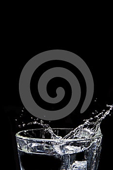 Water splashes on glass on isolated black background