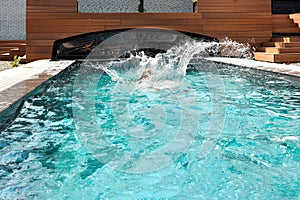 Water splashes in home swimming pool outdoor