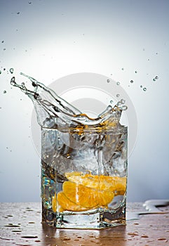 Water splashes from mandarin slices on a light background