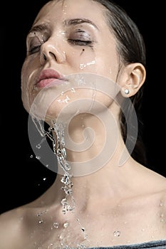 Water splashes on woman`s face