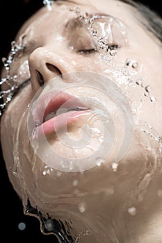 Water splashes on woman`s face