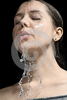 Water splashes on woman`s face