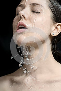 Water splashes on woman`s face