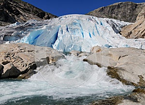 Water Splashing At The Bottom Of The Glacier Nigardsbreen In Jostedalsbreen National Park