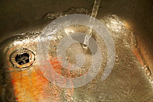 Water splashing down in the sink, close up.