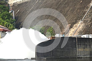 water splashing from floodgate Khun Dan Prakarn Chon huge concrete dam in Thailand photo