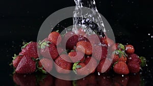 Water splashing on fresh strawberries