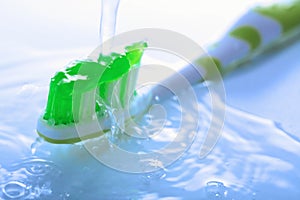 Water splashing over toothbrush