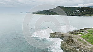 Water sports and activity on cloudy vacation day, with Lanikai on background 4K