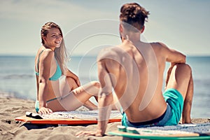 Water sports. Attractive couple outdoors â€“ Smiling surfers on