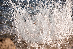 Water spray produced by wave on beachline