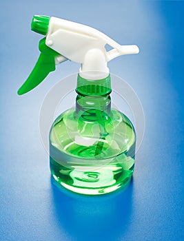 Water sprayer bottle on blue