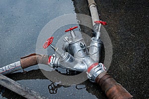 Fire hose and tee for water on the ground