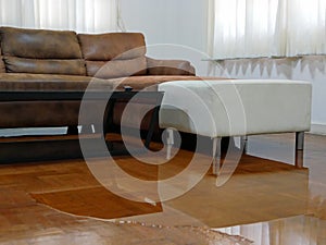 Water spreading / flooding on living room parquet floor in a house - damage caused by water leakage