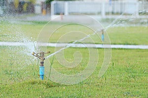 Water sprinkler spray watering in park.