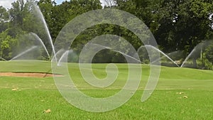 Water Sprinklers Dance Across Golf Course Greens