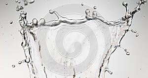 Water spurting out against white background,