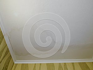 Water stain on the ceiling of the apartment after flooding.