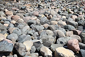 Water stones rocks pattern. Pebbles near water. Round stones background. Nature background. River bed and shore