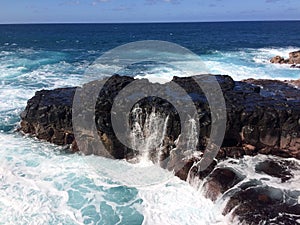 Water Stream Entering Pacific Ocean near Queen`s Bath in Princeville on Kauai Island, Hawaii.