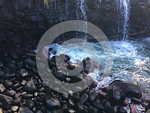 Water Stream Entering Pacific Ocean near Queen`s Bath in Princeville on Kauai Island, Hawaii.