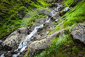 A water stream flowing down the mountain. Waterfalls at Shrikhand Mahadev Kailash Himalaya Yatra. Himachal Pradesh India