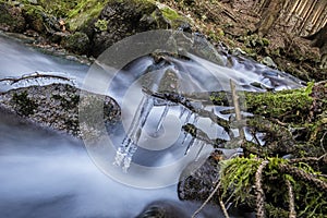 Water stream with icicles in forest, Little Fatra, Slovakia