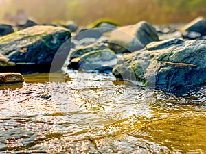 Water stream over rocks soft focus